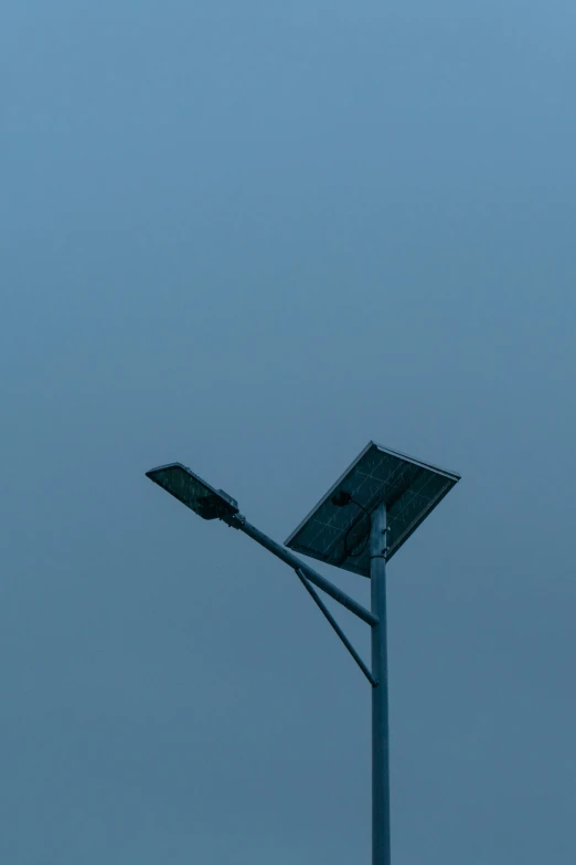 a large street light that is sitting under a pole