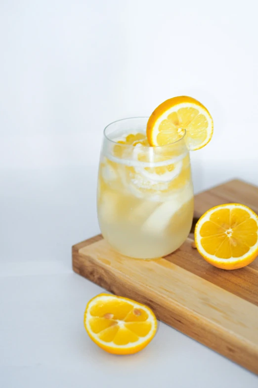 a wooden serving tray with a glass filled with lemonade