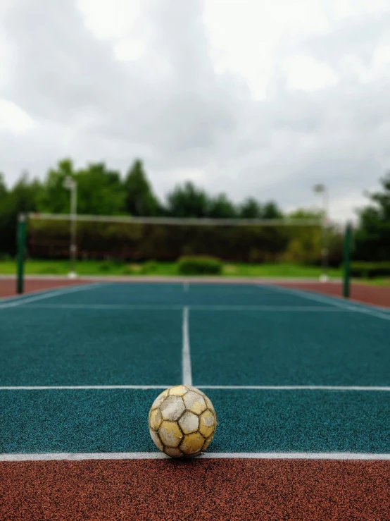 a soccer ball on a court with a net