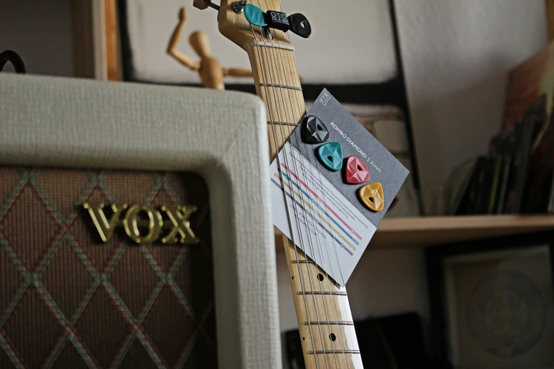 a pair of wooden pegs with an old guitar