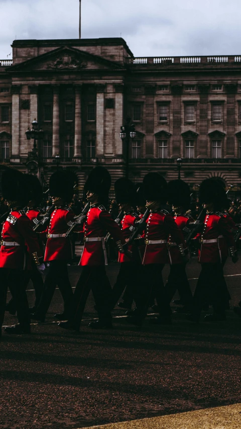 a group of men in red uniforms walking down the street