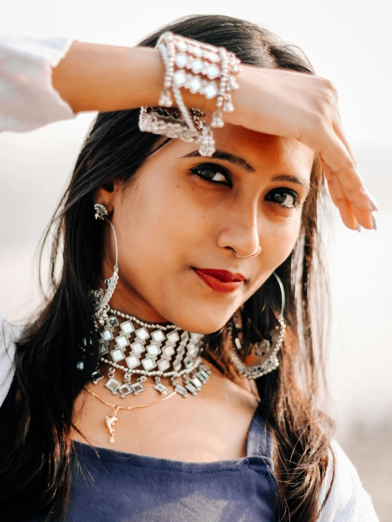 a woman is posing for a picture with a big celet on her neck