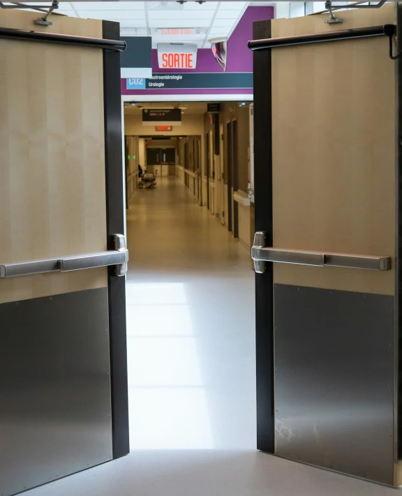 a hallway that has some metal doors on it