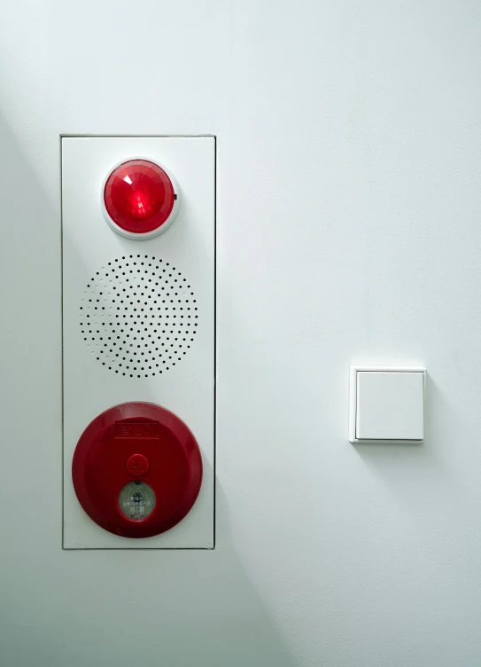 a close up view of a street light, switch plate and a wall