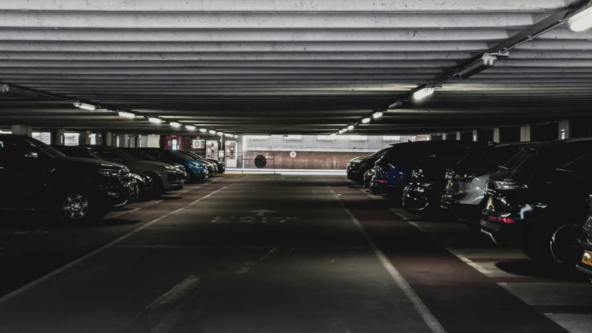 a car parking garage filled with black cars