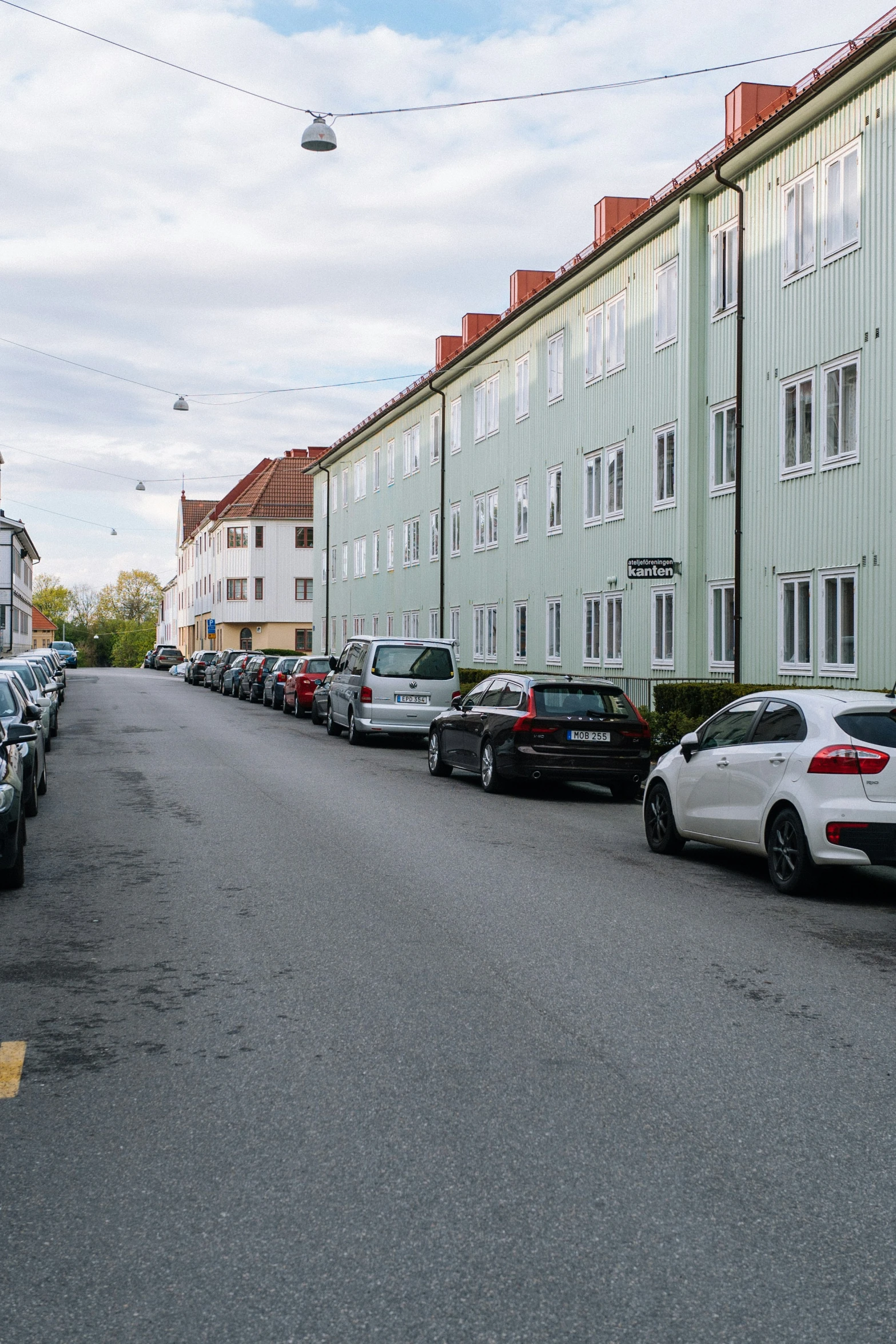 cars parked along side each other on the side of the street