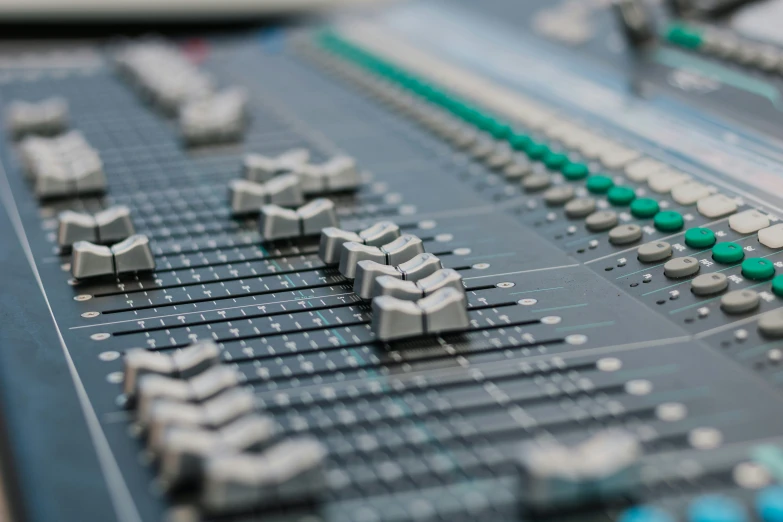 a close up of sound mixing equipment, showing the s and switches