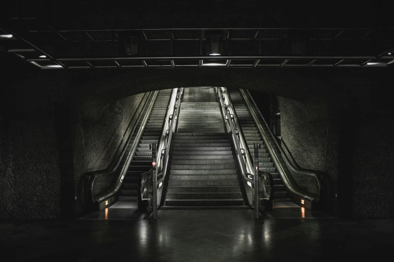 an escalator leading into the dark underground