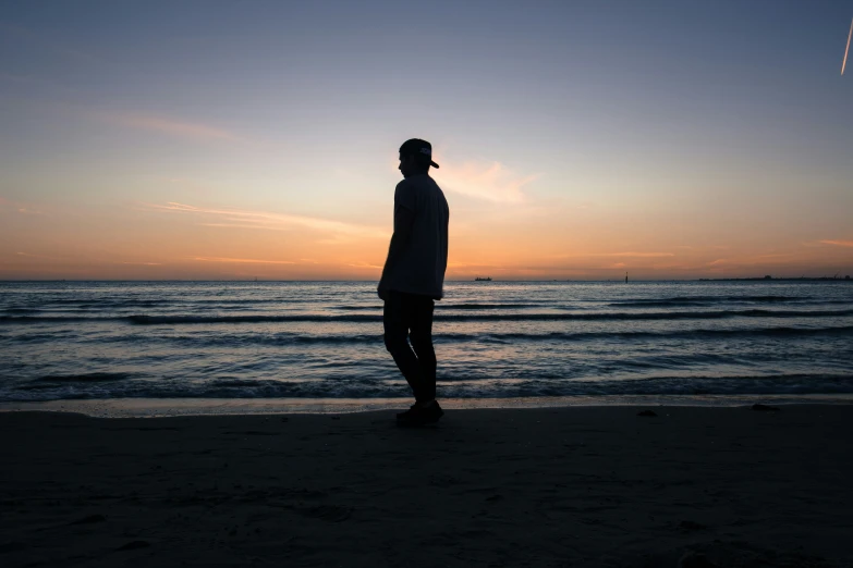 a person standing on top of a sandy beach