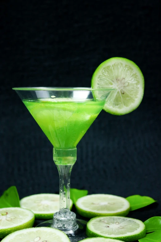 lime juice in a green margarita glass with a slice