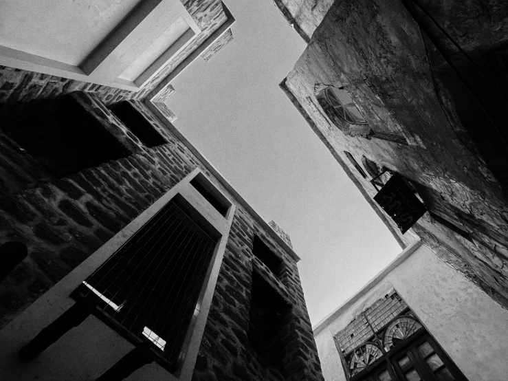 black and white pograph of two building on the street