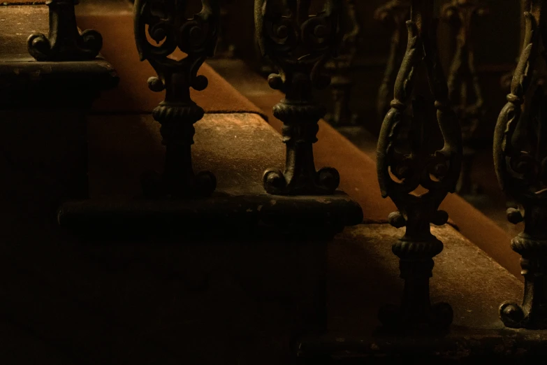 a row of ornately decorated benches next to the wall