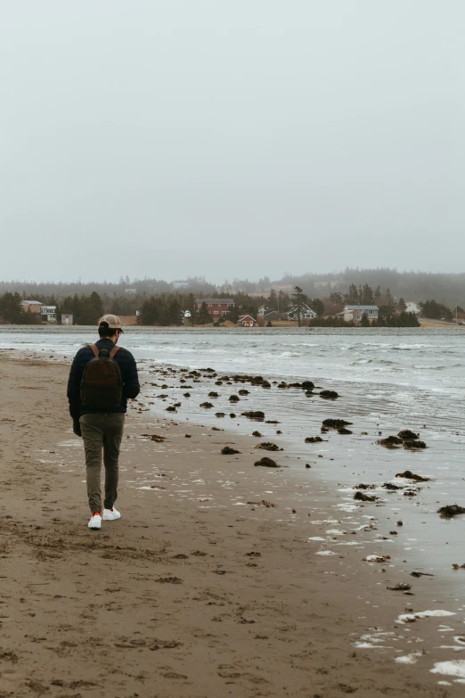 a person walking along the beach towards the water