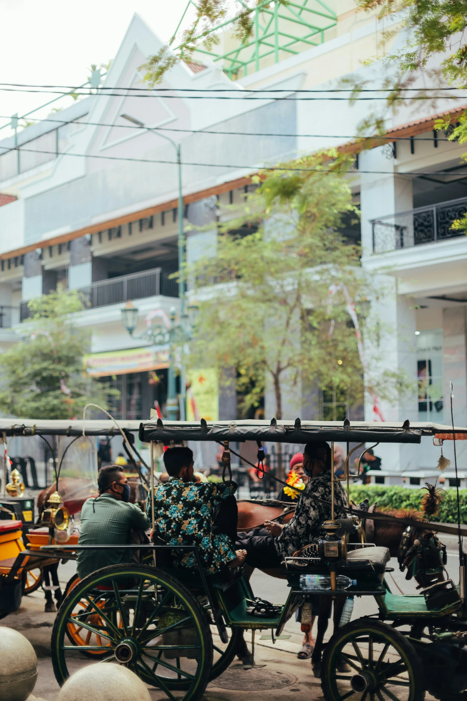 two people ride in an old fashioned cart