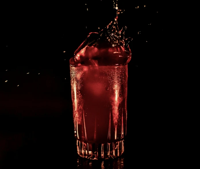 a red and black po of a drink in a glass