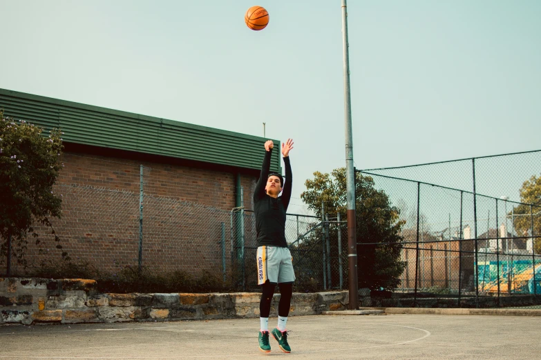 a man is about to dunk a basketball at the hoop