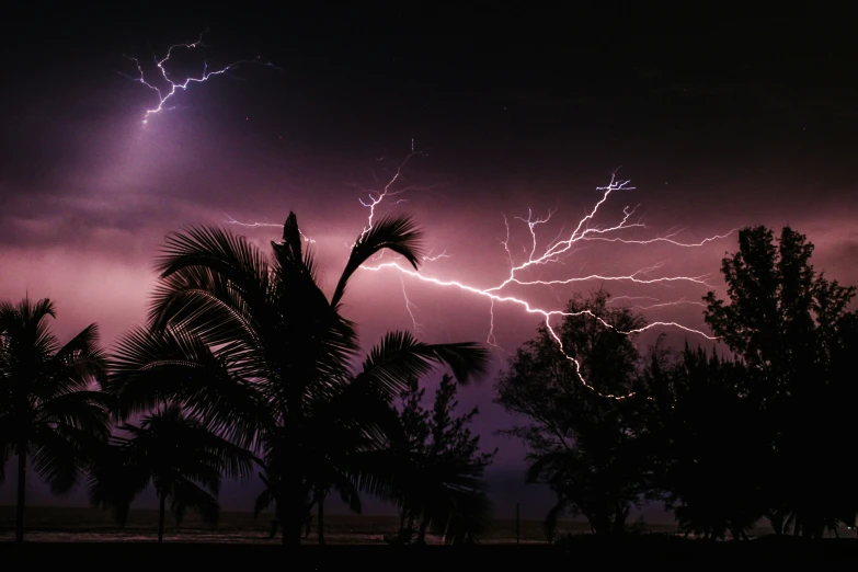 a purple and black sky with a lightning