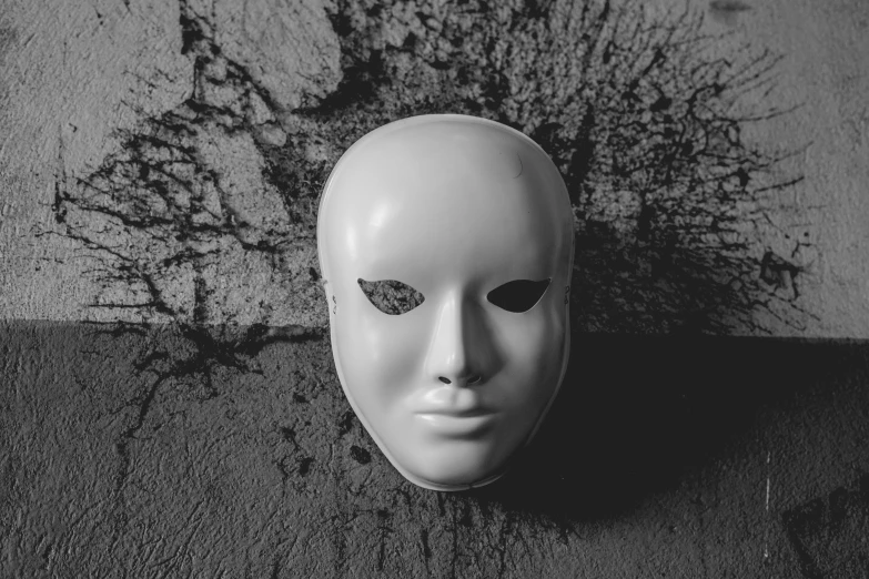 a white mask that is on a gray surface