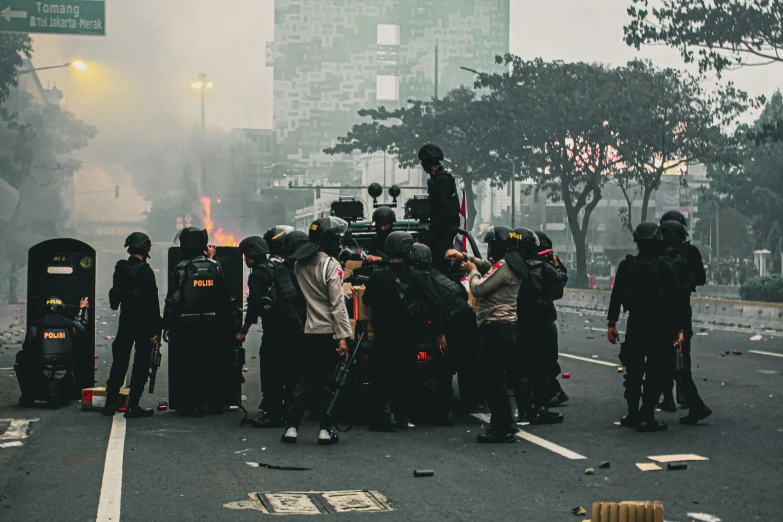 police standing around in the middle of a road with riot gear