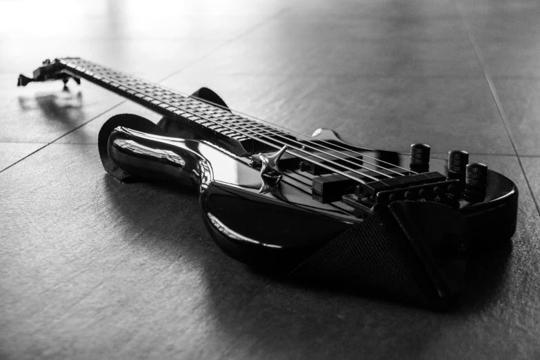 a guitar laying on top of a tiled floor