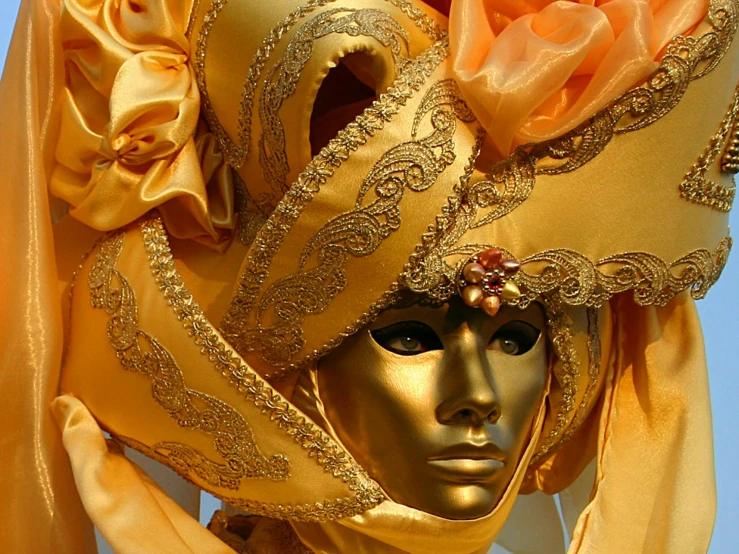 an unusual mask is shown in gold