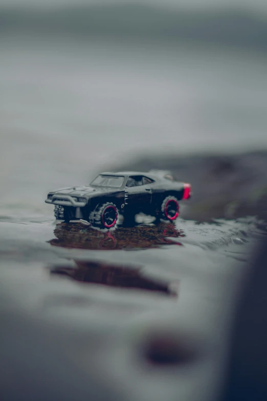 a toy car is sitting in the water