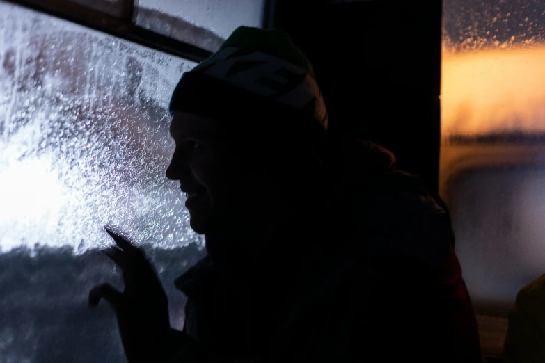 a man standing next to a window in a room