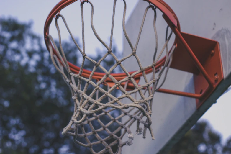 an orange hoop hangs above a basketball net