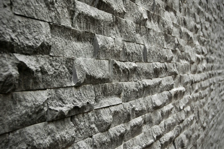 the texture of a brick wall is gray and very unique