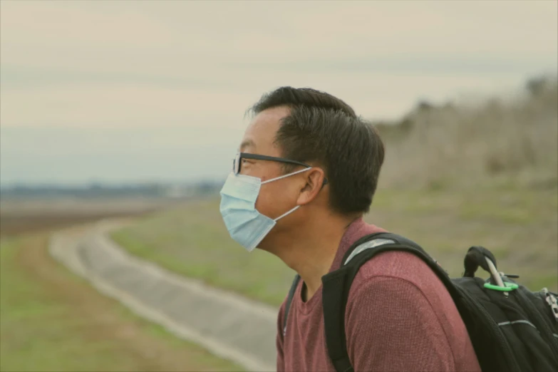 a man wearing a mask on the side of a road