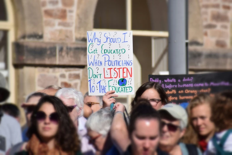 some people are standing with signs and holding them up