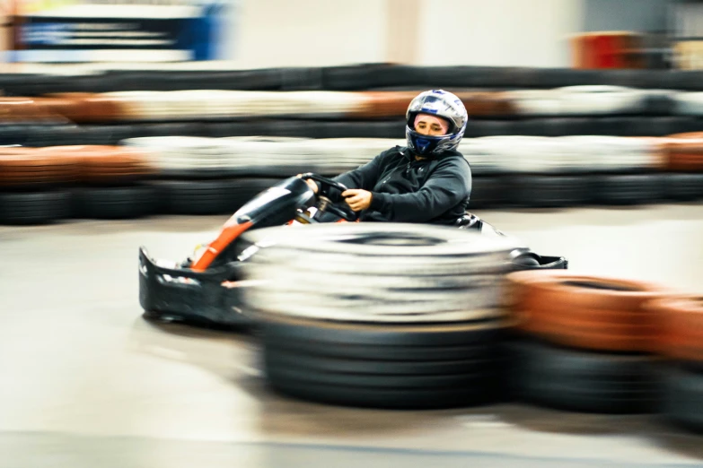 a small boy is sitting on a go kart