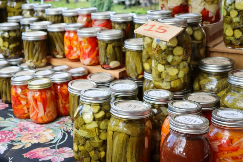 some jars with pickles and peppers on display