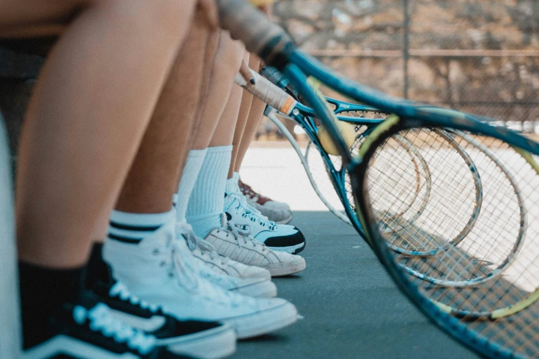 a person holding a tennis racket up in the air