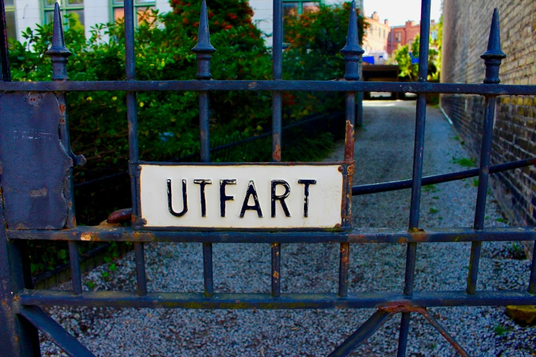 a street sign in front of a gate