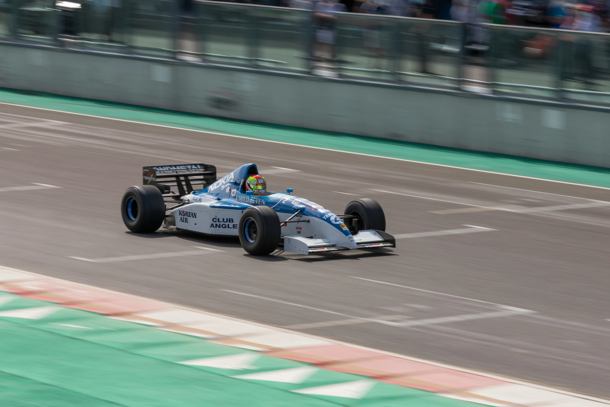 a person in a race car driving down the track