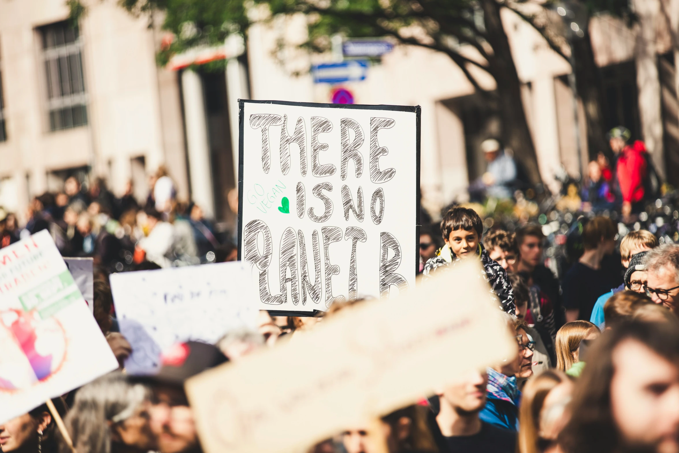 many people are holding up signs while standing