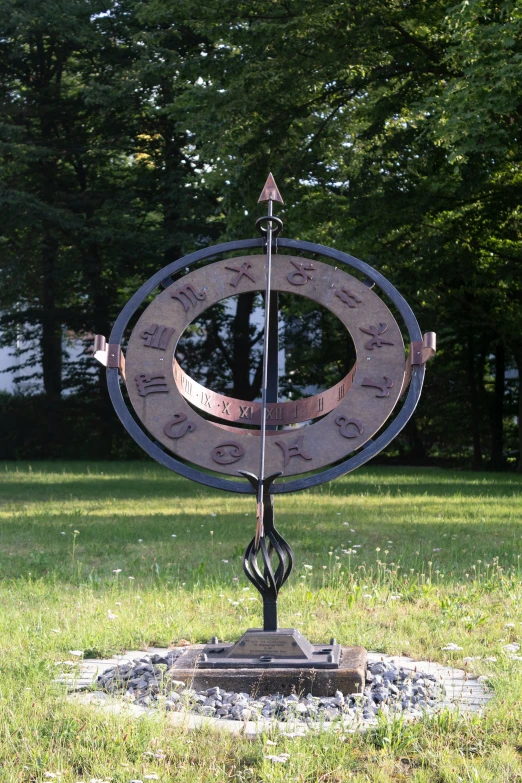 an elaborate circular sculpture with a pole near it
