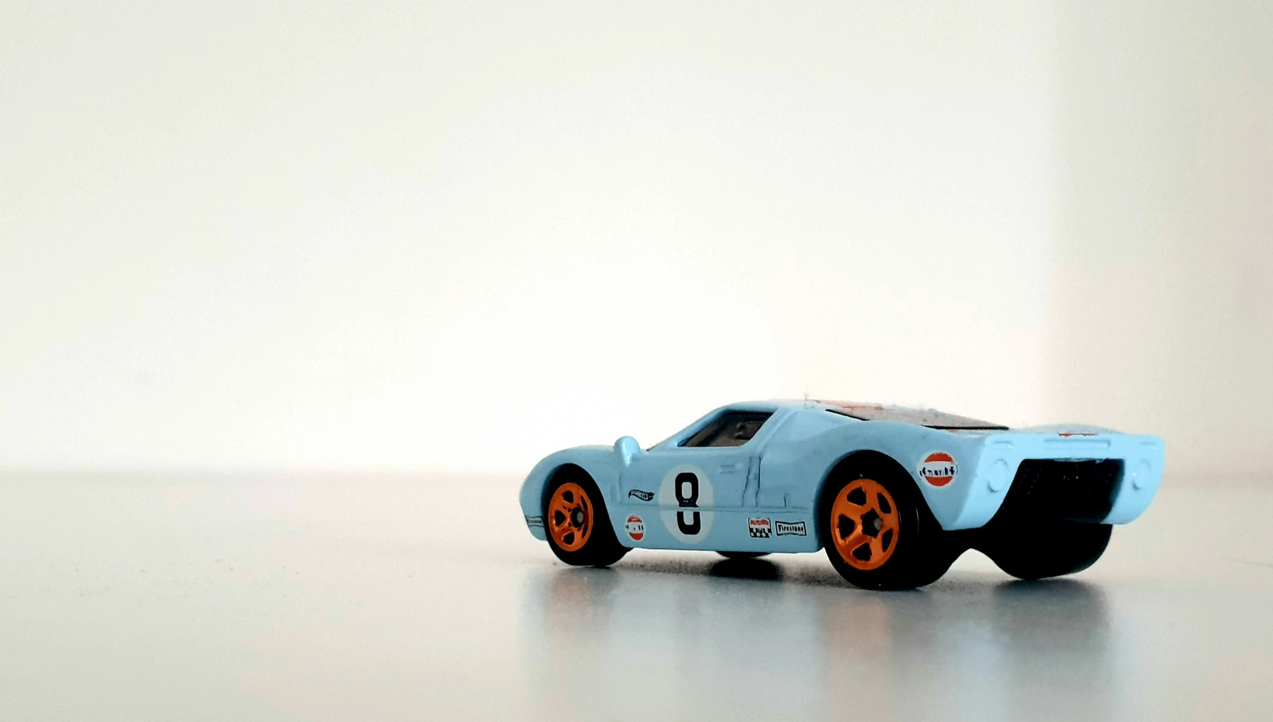 a blue toy race car that is on top of a table