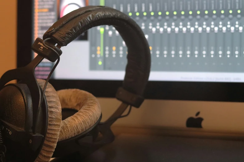 a recording device and headphones near a computer screen