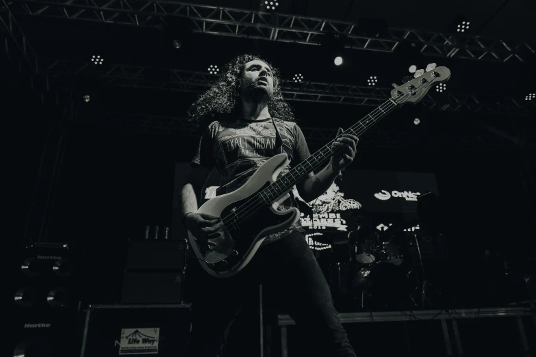 a black and white po of a man playing a guitar