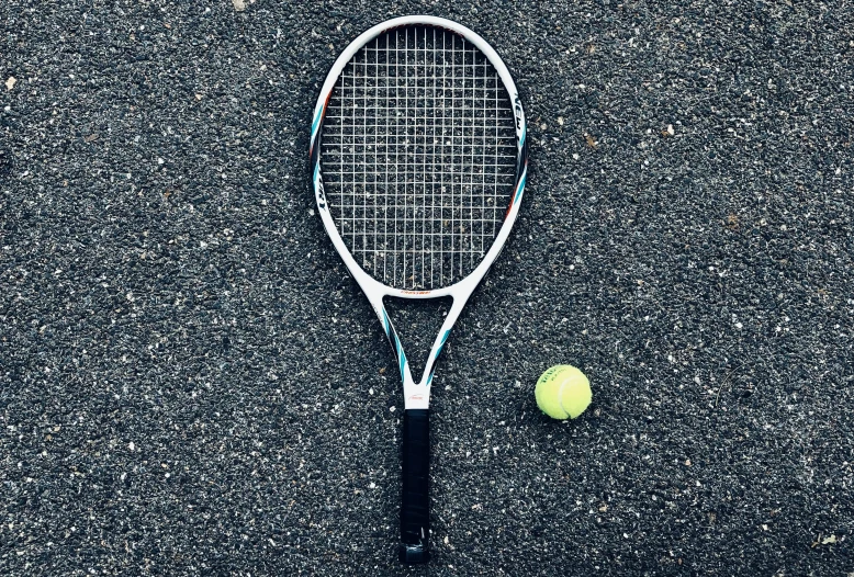 the tennis racket and ball are left on the court