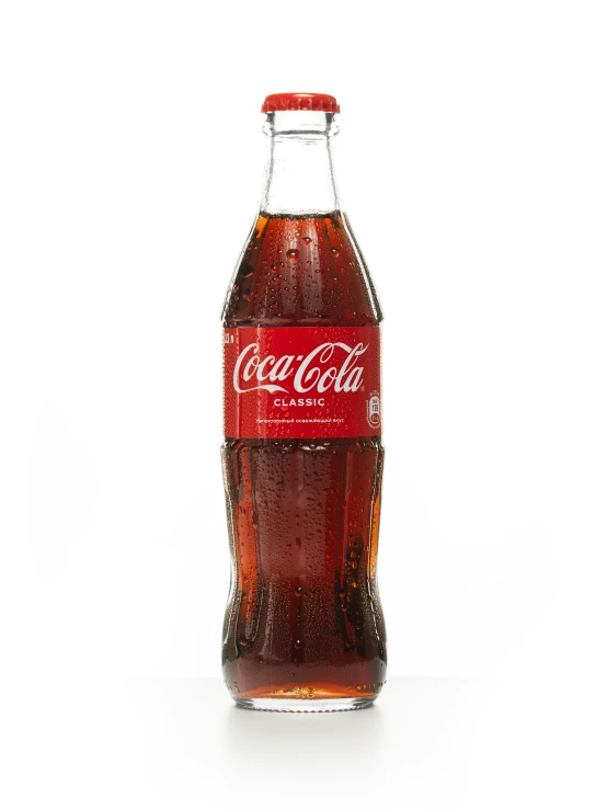 the cola is placed on a white surface