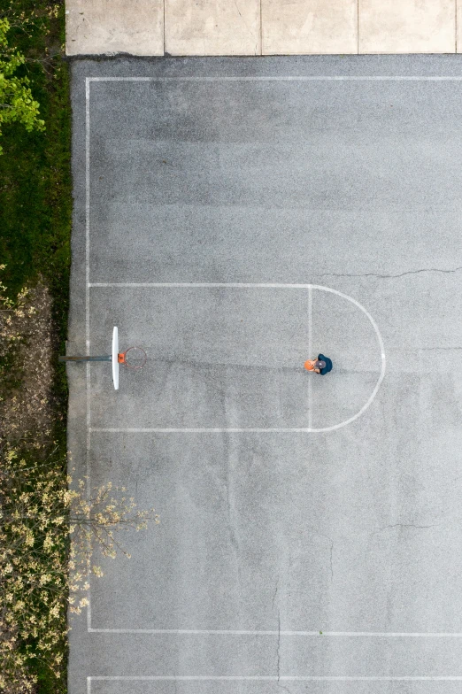 two men standing in an empty basketball court