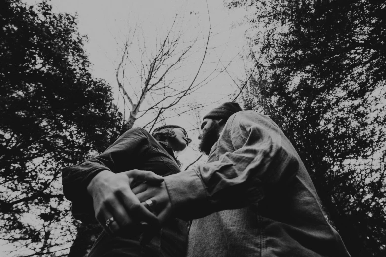 a couple is dancing against the backdrop of tree nches