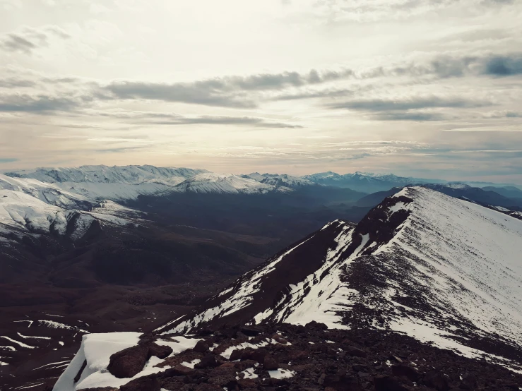 a couple of mountains in the distance with snow on them