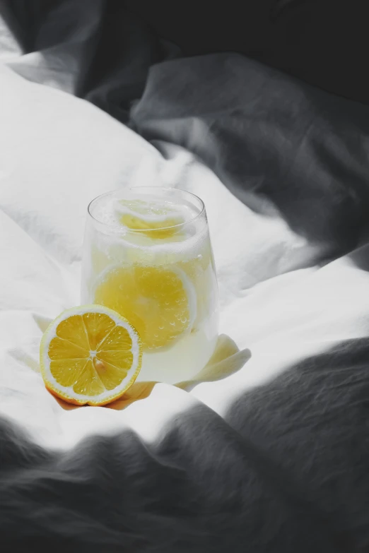 the drink is placed next to the cut orange