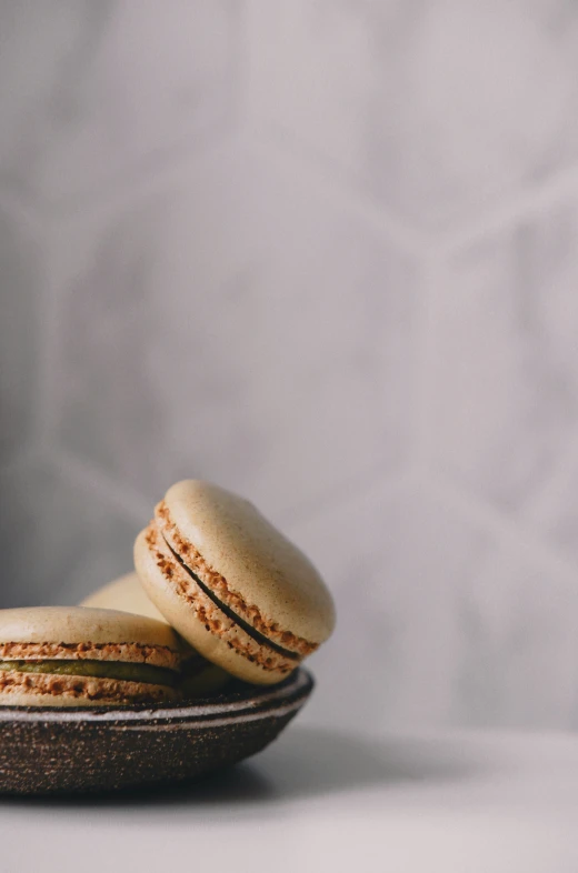 two macarons sitting on top of a wooden tray