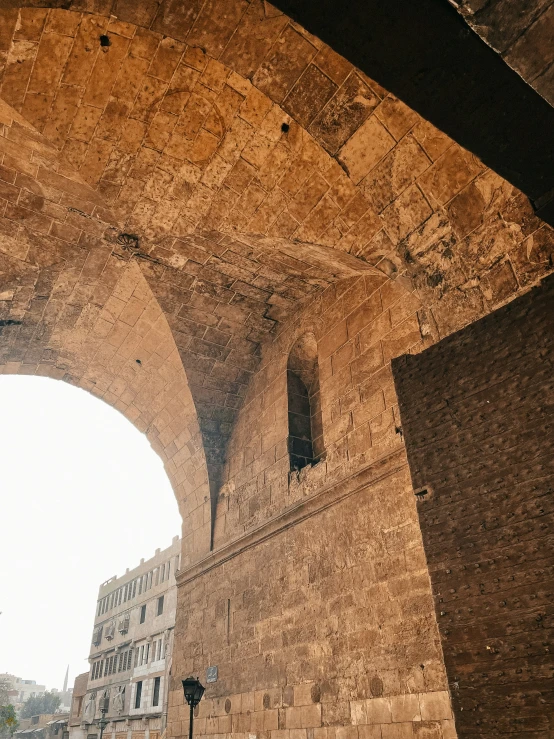 a building that has a stone arch and two clocks