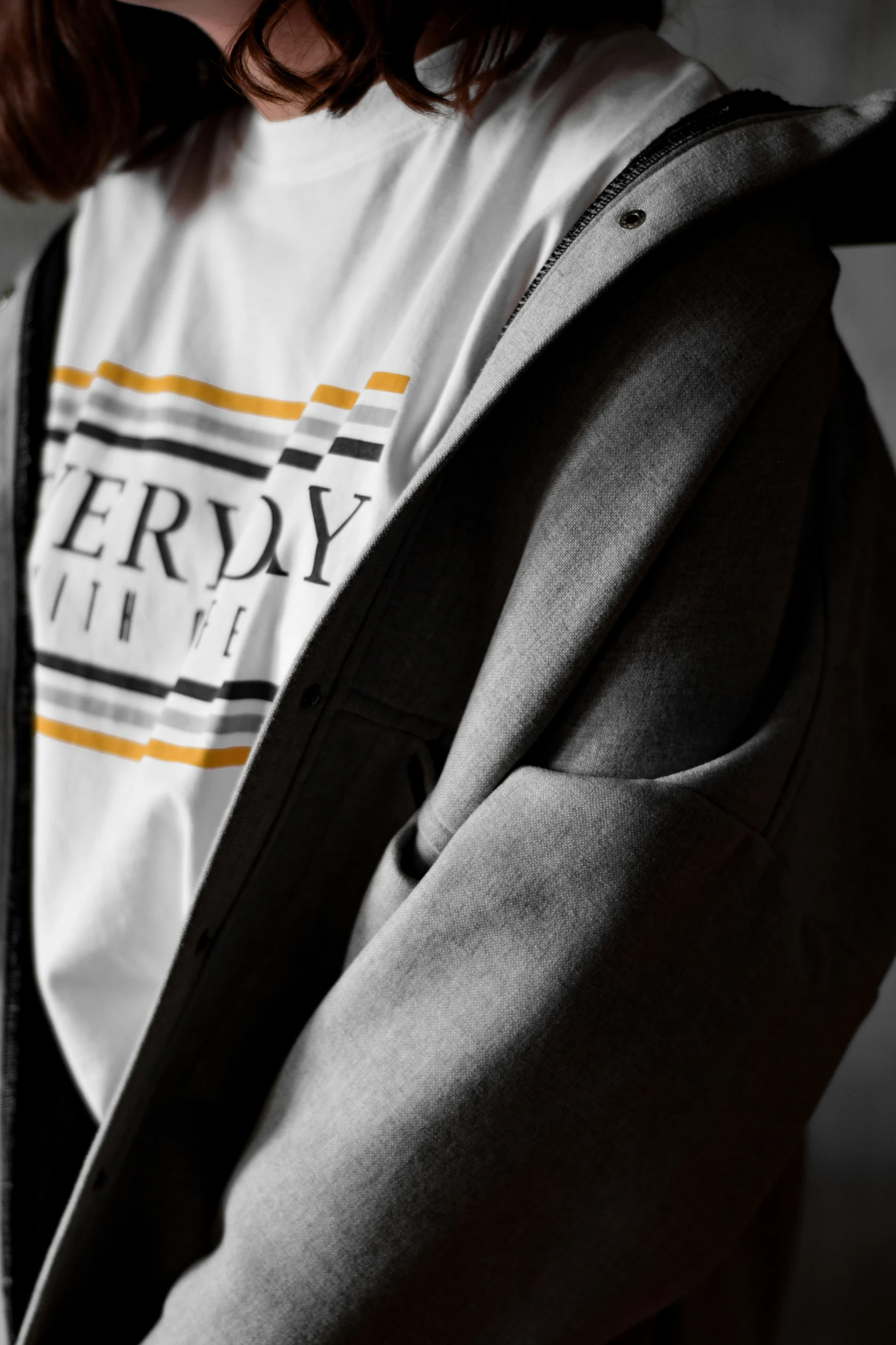 a young man wearing a hoodie looking down